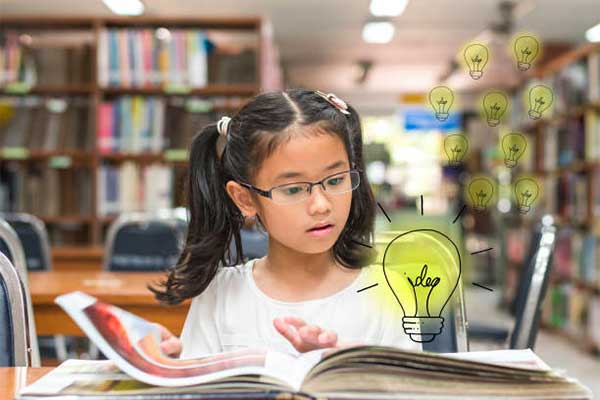 Girl in library practicing her reading.